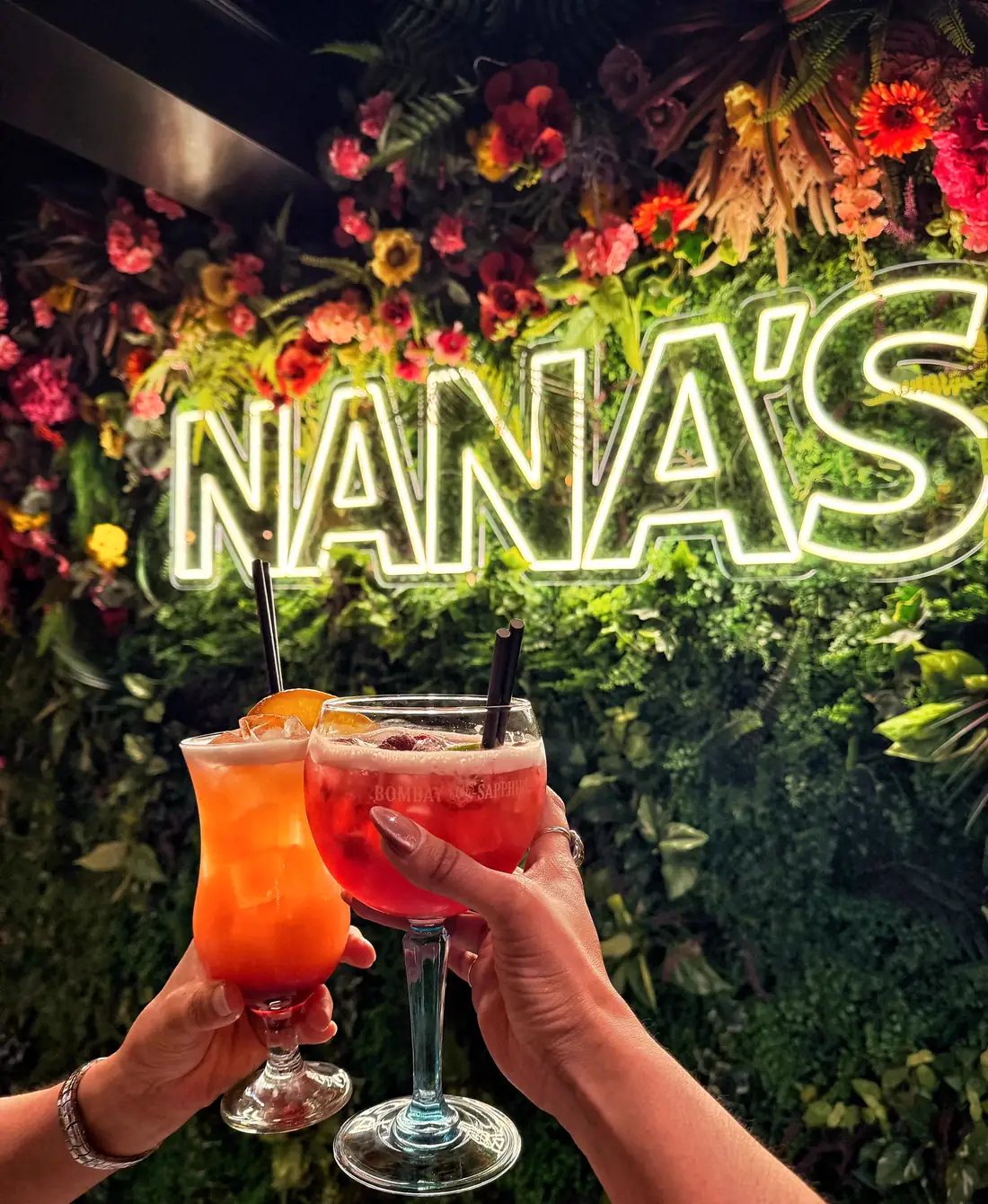 Cocktails in front of the Nana's neon wall